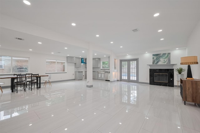 14823 Forest Lodge Dr, Houston, TX 77070 - living room featuring visible vents, baseboards, light tile patterned flooring, and a premium fireplace
