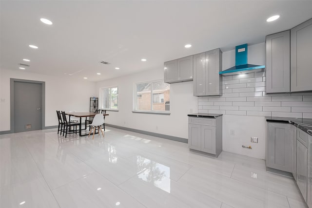 14823 Forest Lodge Dr, Houston, TX 77070 - kitchen featuring visible vents, wall chimney range hood, gray cabinets, tasteful backsplash, and light tile patterned floors