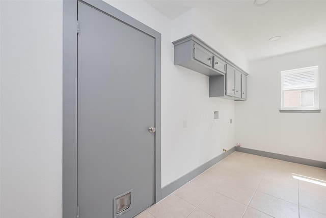 14823 Forest Lodge Dr, Houston, TX 77070 - clothes washing area with light tile patterned floors, washer hookup, baseboards, and cabinet space