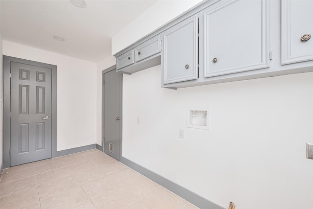 14823 Forest Lodge Dr, Houston, TX 77070 - laundry area with baseboards, washer hookup, cabinet space, and light tile patterned floors