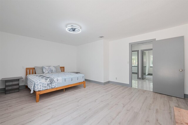 14823 Forest Lodge Dr, Houston, TX 77070 - bedroom with baseboards, wood finished floors, and visible vents