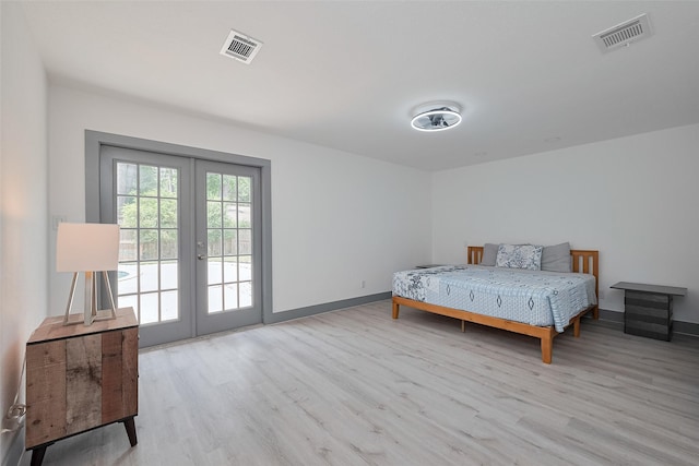 14823 Forest Lodge Dr, Houston, TX 77070 - bedroom with french doors, light wood-style flooring, and visible vents