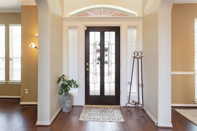 3902 Lakeridge Canyon Dr, Sugar Land, TX 77498 - foyer with arched walkways, dark wood-style floors, crown molding, and baseboards