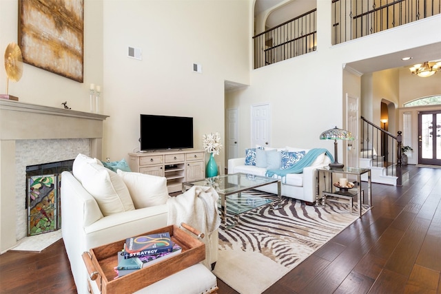 3902 Lakeridge Canyon Dr, Sugar Land, TX 77498 - living room with a towering ceiling, arched walkways, hardwood / wood-style floors, a fireplace, and stairway