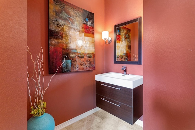 3902 Lakeridge Canyon Dr, Sugar Land, TX 77498 - bathroom featuring vanity, baseboards, a textured wall, and tile patterned floors