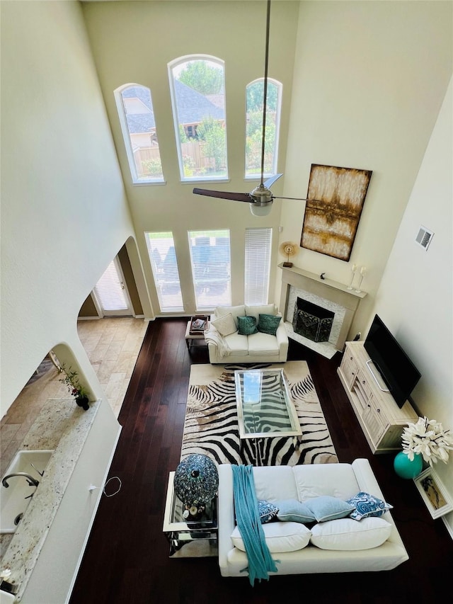 3902 Lakeridge Canyon Dr, Sugar Land, TX 77498 - living area featuring a fireplace, wood-type flooring, and a high ceiling