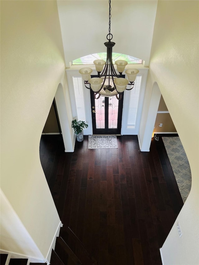 3902 Lakeridge Canyon Dr, Sugar Land, TX 77498 - foyer with a high ceiling, a chandelier, hardwood / wood-style flooring, and baseboards