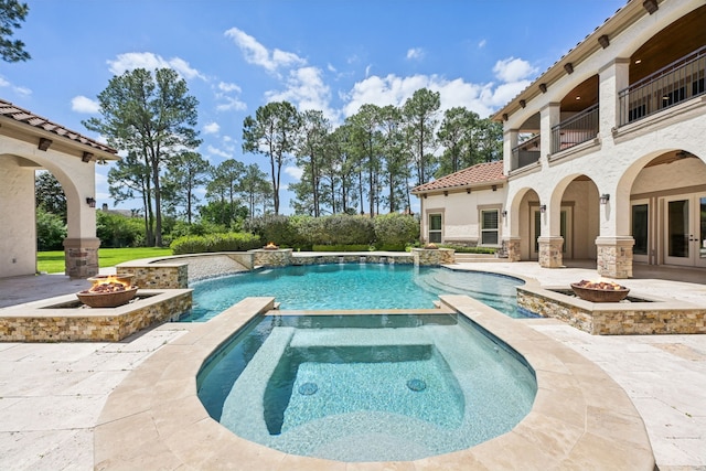 2102 Countryshire Ln, Richmond, TX 77406 - view of swimming pool featuring a fire pit, french doors, a pool with connected hot tub, and a patio