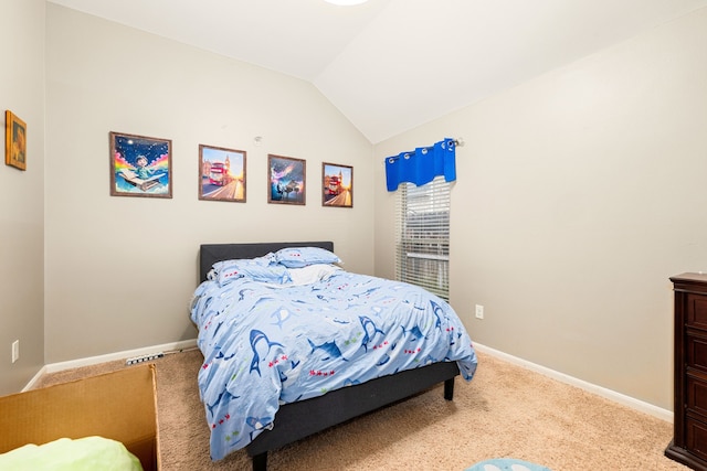 carpeted bedroom with vaulted ceiling and baseboards