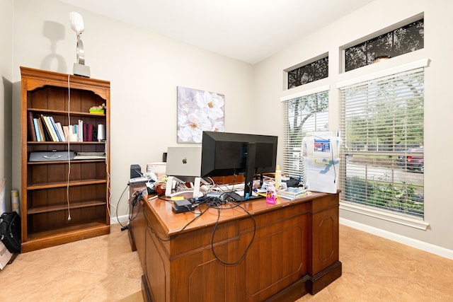 office area featuring baseboards and light tile patterned floors