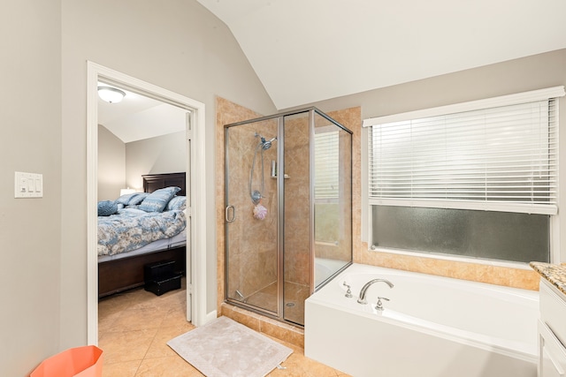 full bathroom featuring a shower stall, connected bathroom, a bath, tile patterned floors, and lofted ceiling