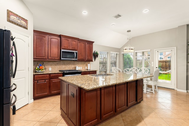 kitchen featuring a sink, stainless steel appliances, light tile patterned floors, visible vents, and vaulted ceiling