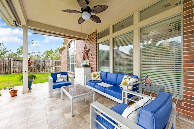 view of patio with outdoor lounge area, fence, a ceiling fan, and visible vents