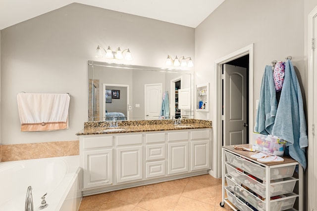ensuite bathroom featuring tile patterned floors, ensuite bath, a bath, and vanity