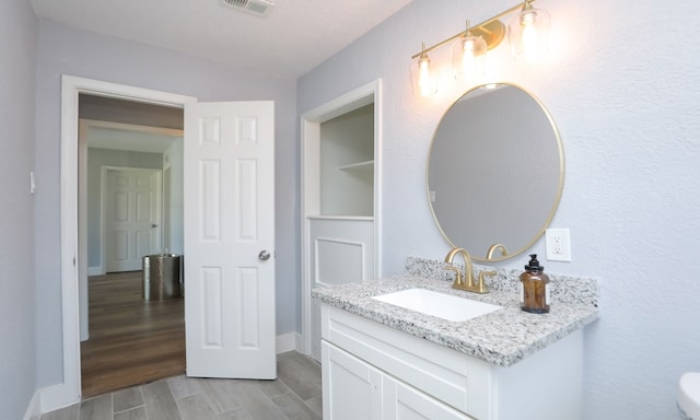 4538 Clover St, Houston, TX 77051 - bathroom with baseboards, wood finished floors, visible vents, and vanity