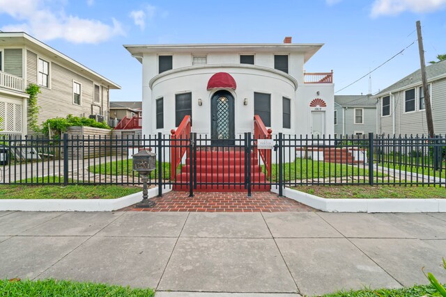 1919 Rosenberg St, Galveston, TX 77550 - view of front of house with a fenced front yard, stucco siding, a gate, and a chimney