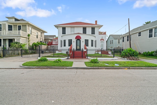 view of front of property featuring a chimney, a residential view, and a fenced front yard