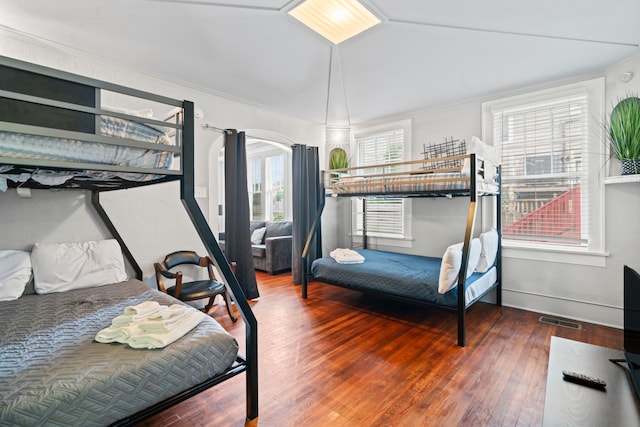 1919 Rosenberg St, Galveston, TX 77550 - bedroom with hardwood / wood-style floors, arched walkways, and ornamental molding