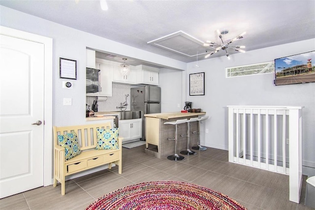 interior space featuring attic access and tile patterned flooring