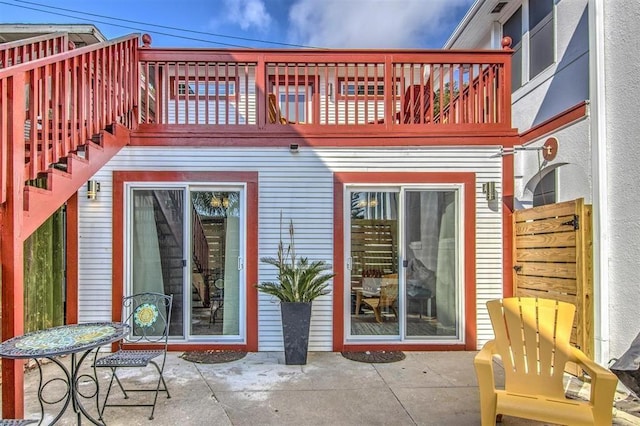 back of property featuring a patio area and a balcony