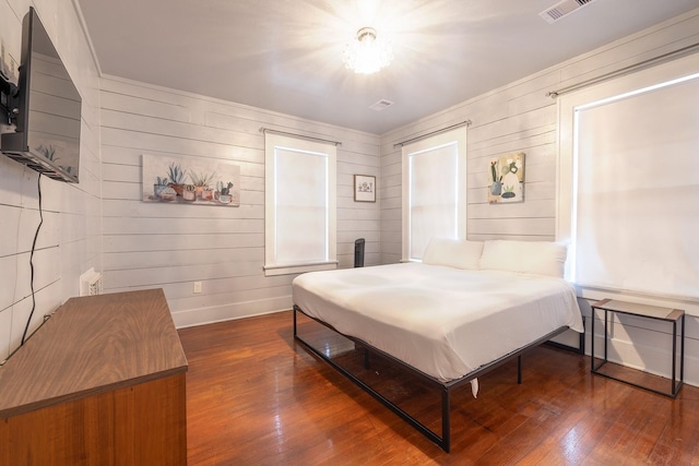bedroom featuring baseboards, visible vents, and wood-type flooring