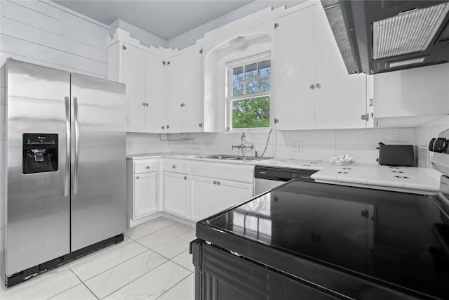 1919 Rosenberg St, Galveston, TX 77550 - kitchen featuring stainless steel fridge, a sink, range with electric cooktop, white cabinets, and light countertops