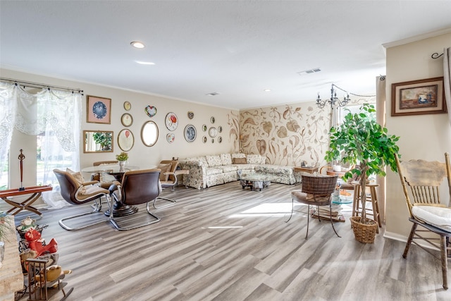 living room with crown molding, wood finished floors, baseboards, visible vents, and recessed lighting