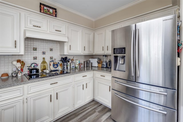 kitchen featuring white cabinets, stainless steel fridge with ice dispenser, custom exhaust hood, and black electric cooktop