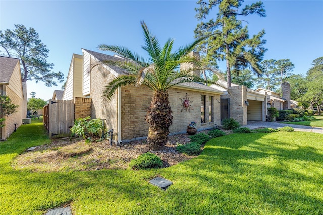 view of front of house with an attached garage, gravel driveway, and a front yard
