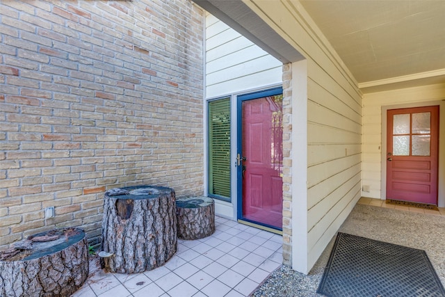 doorway to property with brick siding