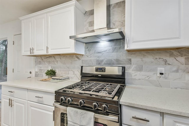105 E Wavy Oak Cir, The Woodlands, TX 77381 - kitchen featuring wall chimney range hood, gas stove, white cabinets, and tasteful backsplash