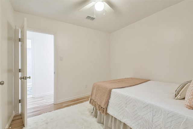 105 E Wavy Oak Cir, The Woodlands, TX 77381 - bedroom featuring baseboards, light wood-style flooring, and ceiling fan