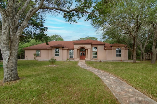 250 Bucek Ln, Schulenburg, TX 78956 - mediterranean / spanish-style home with stucco siding and a front yard
