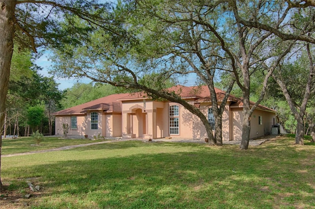 250 Bucek Ln, Schulenburg, TX 78956 - mediterranean / spanish-style house featuring stucco siding and a front lawn