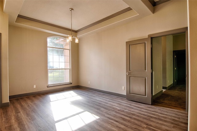 250 Bucek Ln, Schulenburg, TX 78956 - empty room featuring a tray ceiling, crown molding, dark wood-style flooring, and baseboards