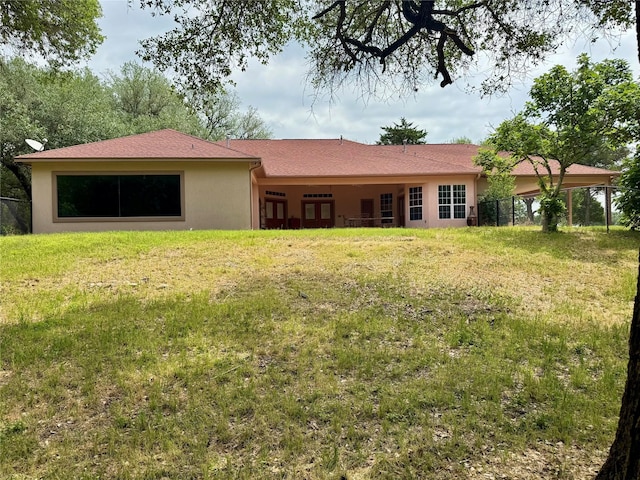 250 Bucek Ln, Schulenburg, TX 78956 - back of house with a yard, stucco siding, and fence