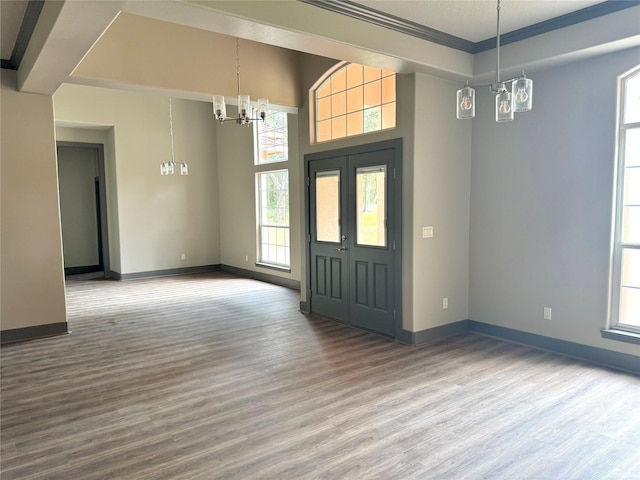 250 Bucek Ln, Schulenburg, TX 78956 - foyer entrance with a notable chandelier, baseboards, plenty of natural light, and wood finished floors