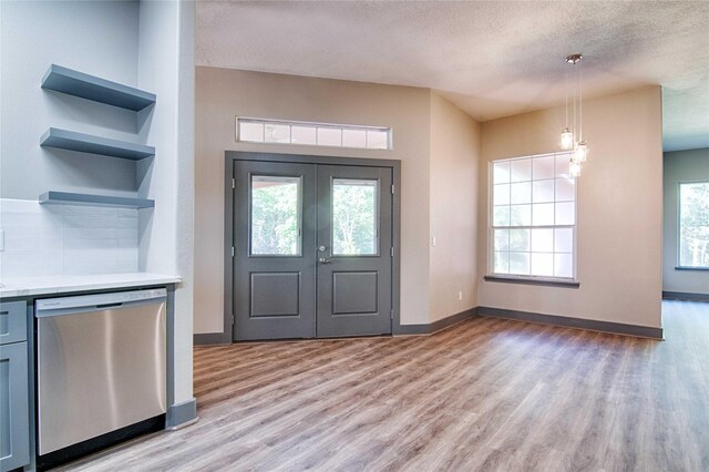 250 Bucek Ln, Schulenburg, TX 78956 - foyer featuring baseboards, light wood-style floors, french doors, and a textured ceiling