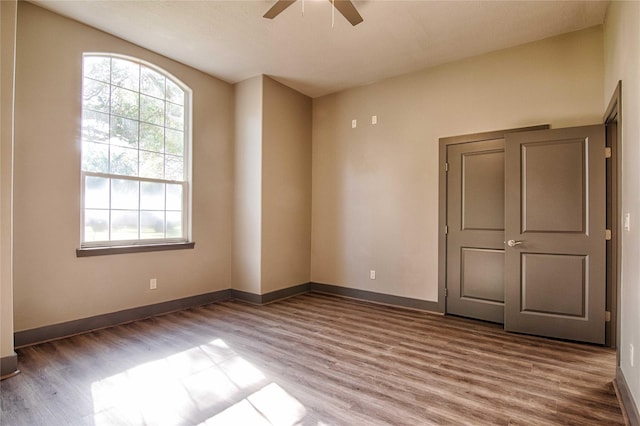 250 Bucek Ln, Schulenburg, TX 78956 - unfurnished room featuring baseboards, wood finished floors, and a ceiling fan
