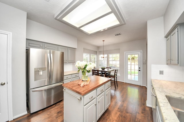 14019 Ivy Bluff Ct, Houston, TX 77062 - kitchen featuring wooden counters, gray cabinets, stainless steel refrigerator with ice dispenser, dark wood-style flooring, and visible vents