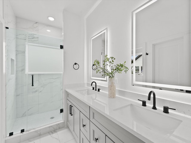 bathroom with marble finish floor, a sink, a marble finish shower, and recessed lighting