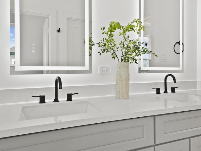 bathroom featuring a sink and double vanity