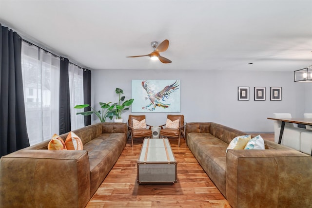 8924 Chatsworth Dr, Houston, TX 77024 - living room featuring ceiling fan, light wood-style floors, and a chandelier