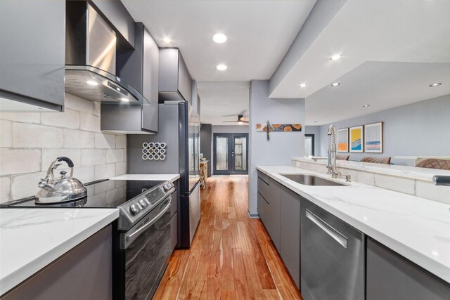 8924 Chatsworth Dr, Houston, TX 77024 - kitchen with wall chimney exhaust hood, a sink, dishwasher, electric range, and modern cabinets