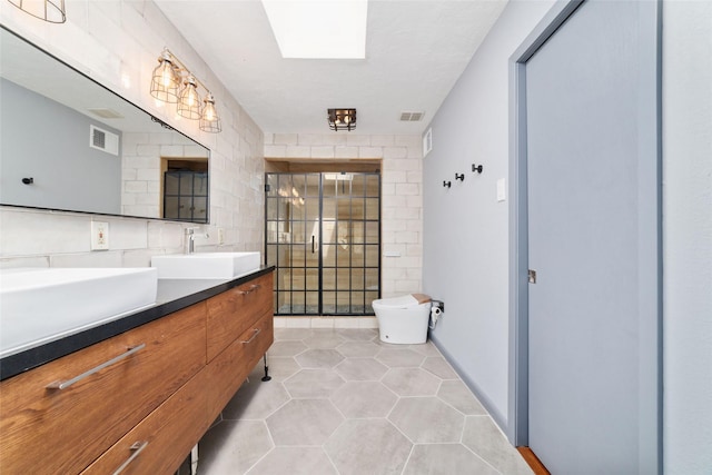 8924 Chatsworth Dr, Houston, TX 77024 - bathroom featuring double vanity, tile patterned floors, and toilet