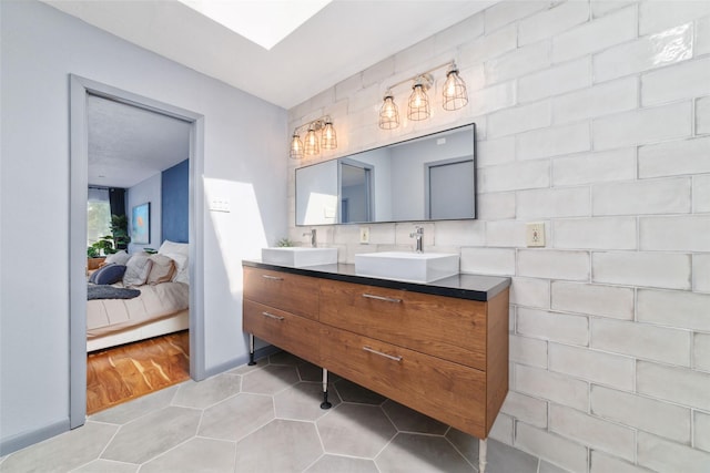 8924 Chatsworth Dr, Houston, TX 77024 - full bathroom with double vanity, ensuite bathroom, tile patterned flooring, and tasteful backsplash