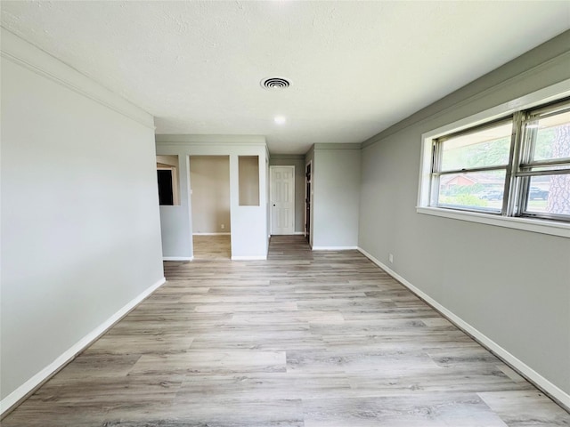 7905 Turquoise Ln, Houston, TX 77055 - empty room with baseboards, light wood-style floors, and crown molding