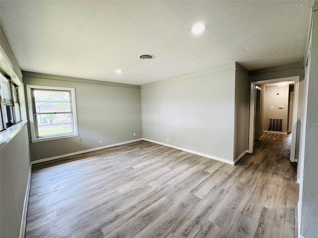 7905 Turquoise Ln, Houston, TX 77055 - spare room with wood finished floors, a textured ceiling, and baseboards