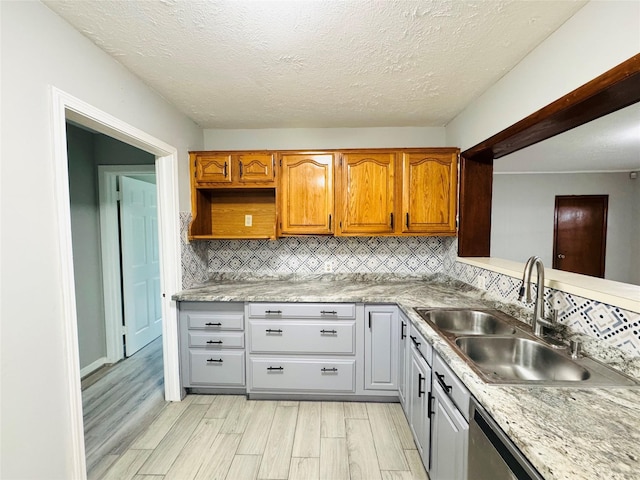 7905 Turquoise Ln, Houston, TX 77055 - kitchen with a sink, light wood-type flooring, tasteful backsplash, light countertops, and a textured ceiling
