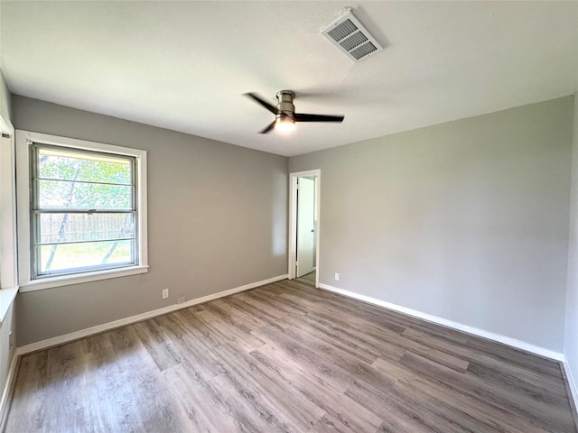 7905 Turquoise Ln, Houston, TX 77055 - empty room with wood finished floors, a ceiling fan, and baseboards